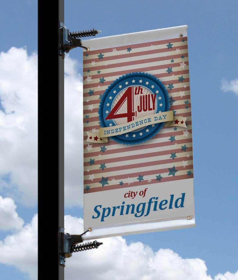 A product picture of a customer street banner displayed on a city street pole.