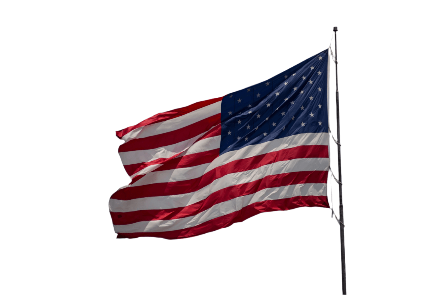 A large American Flag flying in the wind against a white background